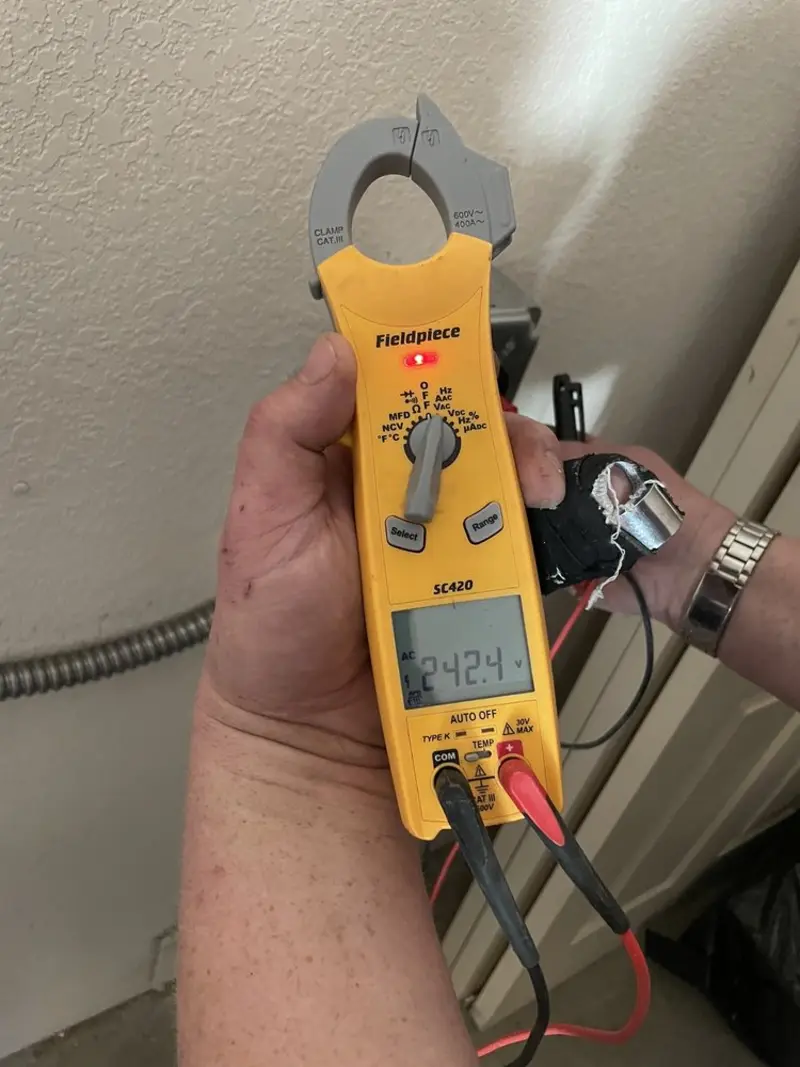 Voltage testing with clamp meter during Electrical Installation Services in Penfield